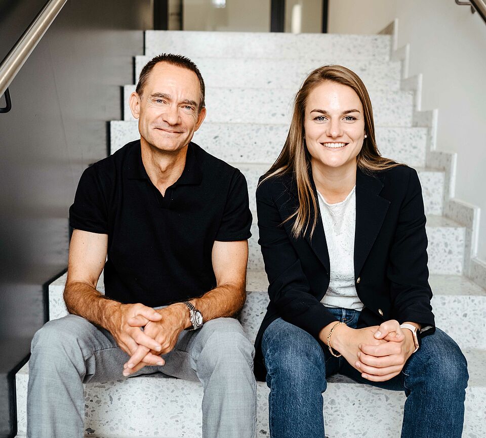 2 people sitting on stairs