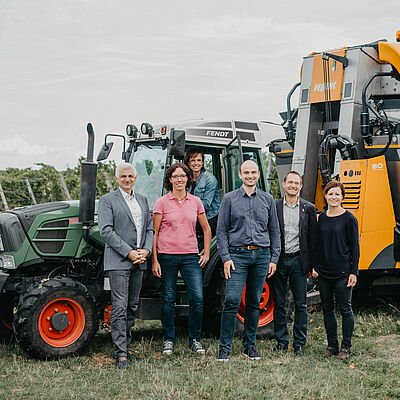 Research team stands in front of tractor with modern attachment