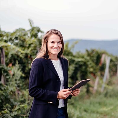 Student with tablet in the vineyard