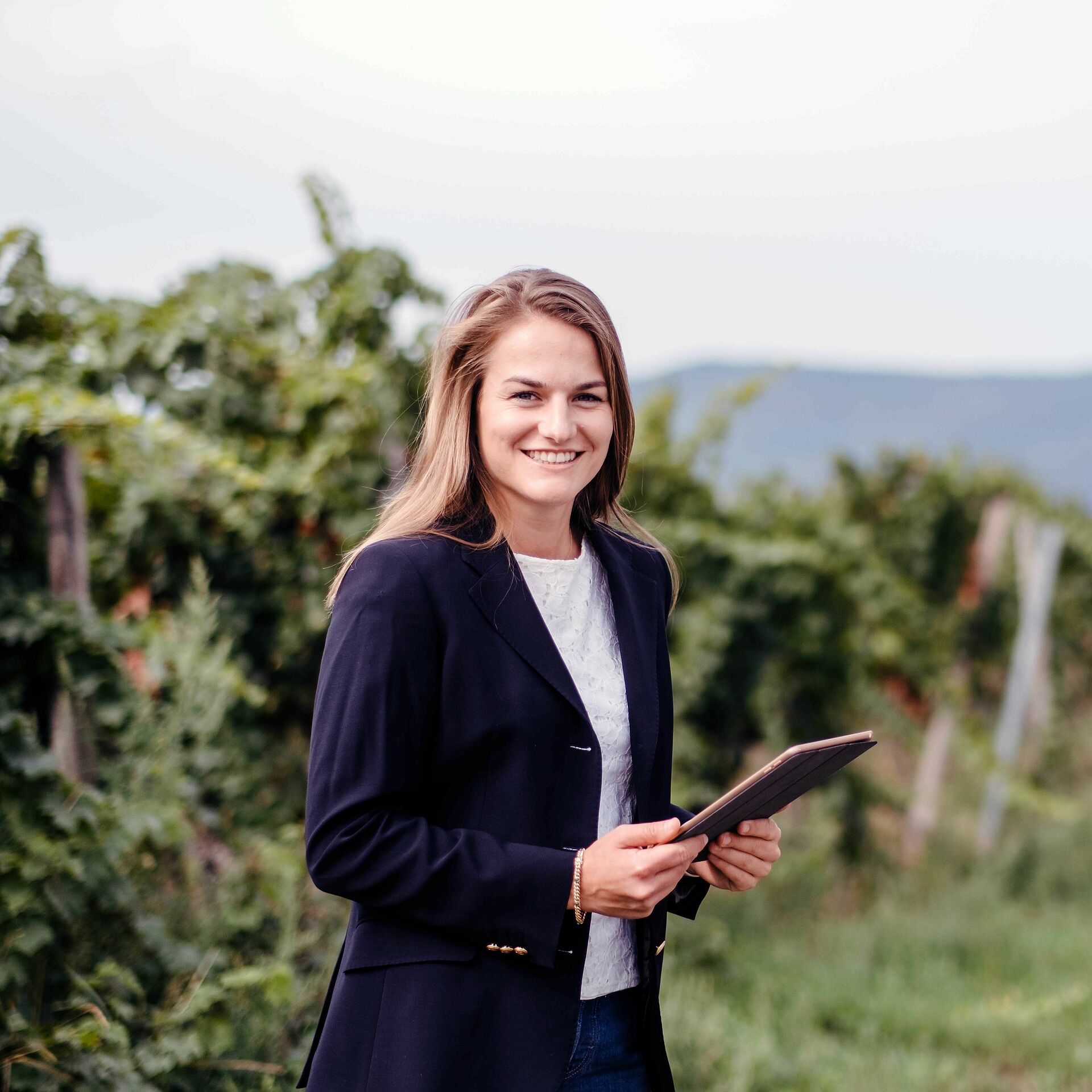 Student with tablet in the vineyard