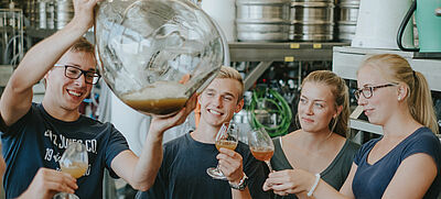 Four students during a wine inspection at the Rural Area Service Center (DLR) Rhenish Palatinate Technical Center