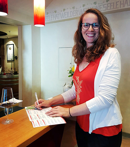 MBA student Franziska Hübsch stands at the wine bar